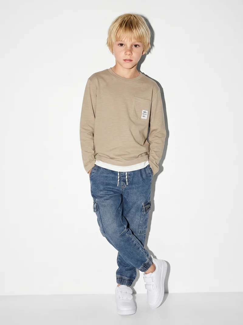 Jogging in denim con tasca laterale - Denim