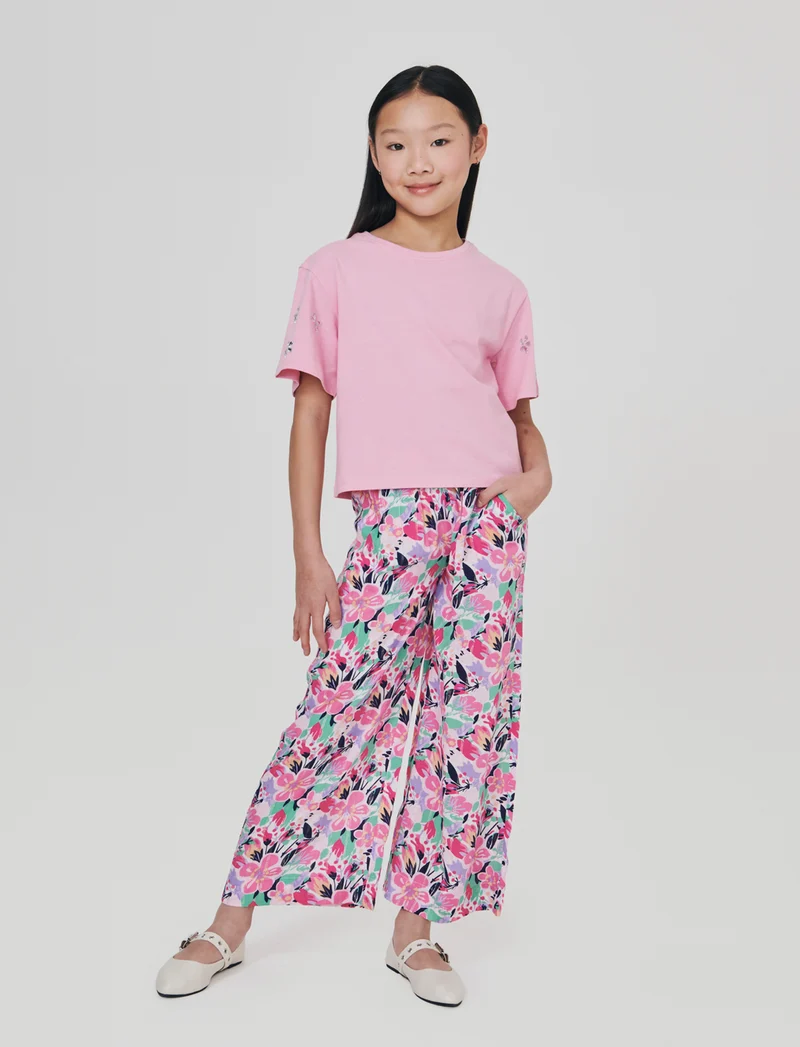 T-shirt ampia con pietre adesive e rib - Rosa